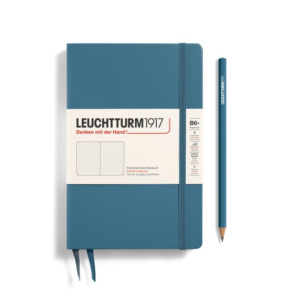 A stone blue notebook with an elastic to keep it closed.
